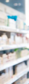 Photo of blurred Pharmacy. Medical product shelves and entry doors.